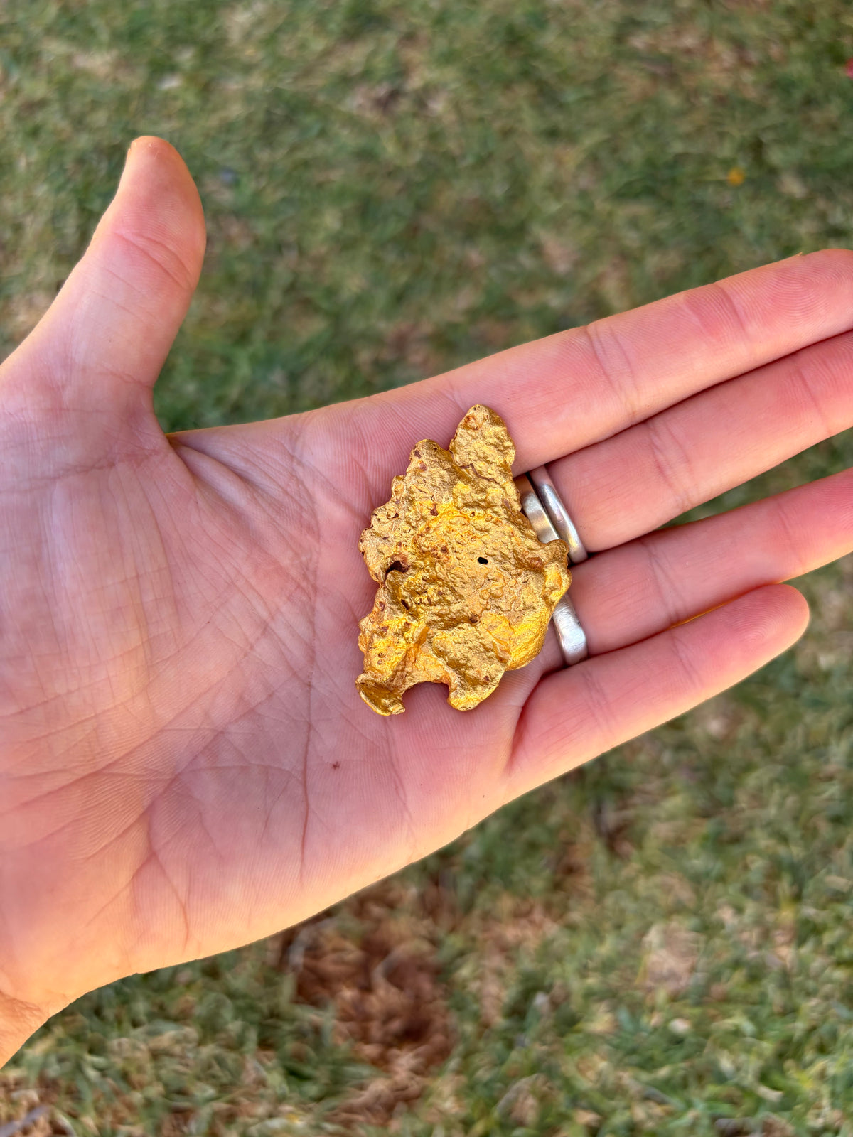 Australian gold nugget held in hand - From our hands to your family heirloom